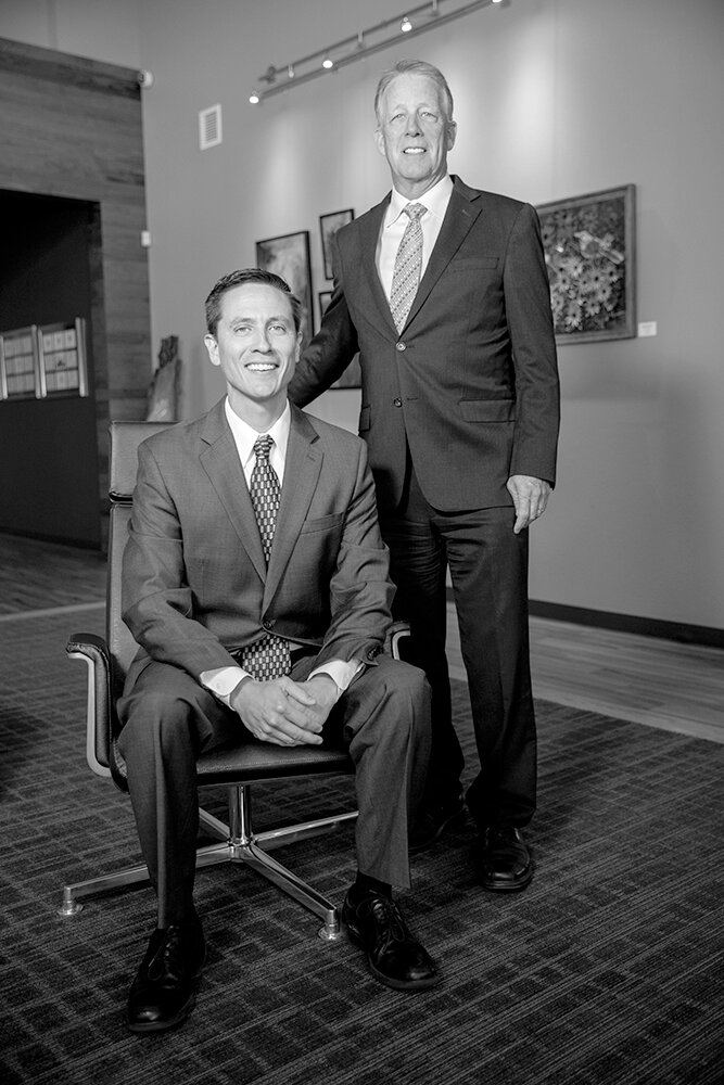 PASSING THE TORCH: Matt Solidum (seated) took on the role of managing partner at Elliott, Robinson & Co. in 2023, after 19 years of leadership by Bob Helm, who remains a partner.